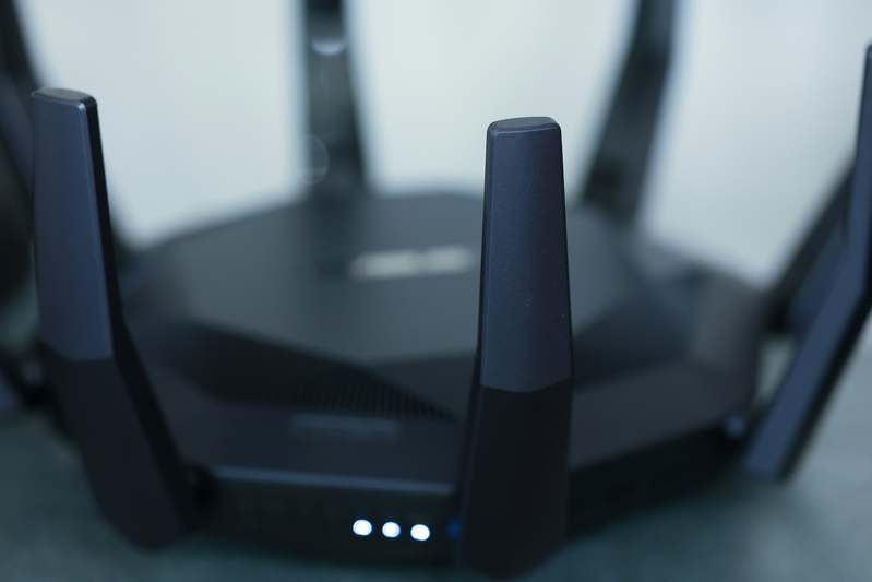 Person configuring home router security settings on laptop
